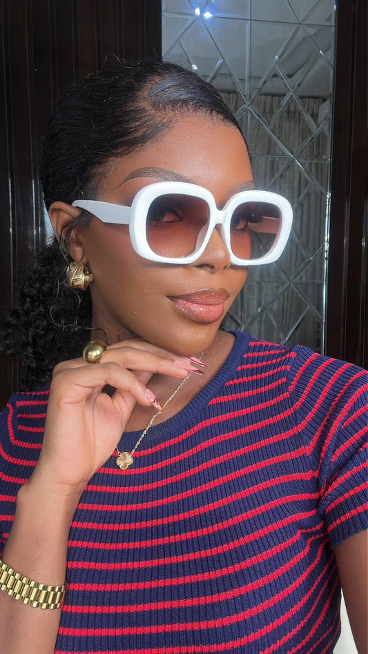 Woman wearing large white sunglasses